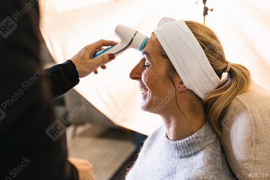 make up assistant cleaning the face of a model with electric brush for a photoshoot or movie on location.  : Stock Photo or Stock Video Download rcfotostock photos, images and assets rcfotostock | RC Photo Stock.: