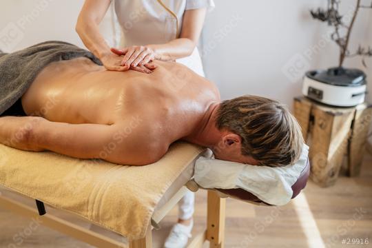 Male client receiving a back massage from a therapist at a modern spa hotel  : Stock Photo or Stock Video Download rcfotostock photos, images and assets rcfotostock | RC Photo Stock.: