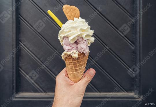 Male hand holding ice cream with cream and cookie against black doorstep. POV image  : Stock Photo or Stock Video Download rcfotostock photos, images and assets rcfotostock | RC Photo Stock.: