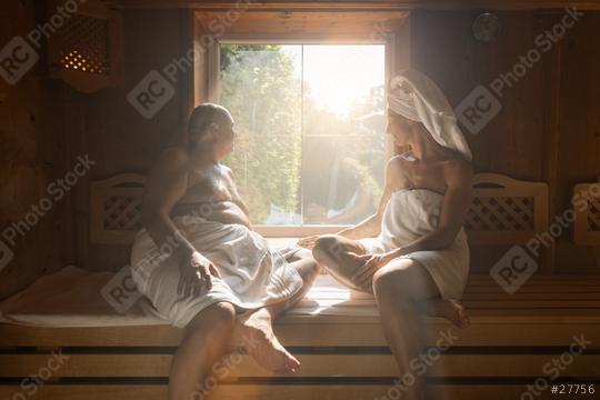 Man and woman sitting opposite each other in a finish sauna, both wrapped in towels, sunlit window at spa hotel  : Stock Photo or Stock Video Download rcfotostock photos, images and assets rcfotostock | RC Photo Stock.: