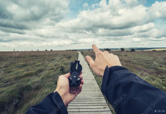 Man explorer searching direction with compass at a cloud day in the  high Venn (Hautes fagnes), point of view.  : Stock Photo or Stock Video Download rcfotostock photos, images and assets rcfotostock | RC Photo Stock.: