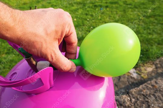 man filling green balloon with helium gas  : Stock Photo or Stock Video Download rcfotostock photos, images and assets rcfotostock | RC Photo Stock.: