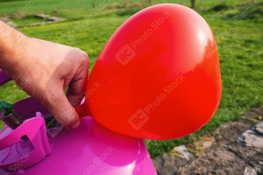 man filling Heart shape balloon with helium gas  : Stock Photo or Stock Video Download rcfotostock photos, images and assets rcfotostock | RC Photo Stock.: