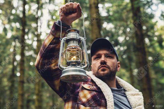 Man hand holding gas lantern in the deep forest  : Stock Photo or Stock Video Download rcfotostock photos, images and assets rcfotostock | RC Photo Stock.: