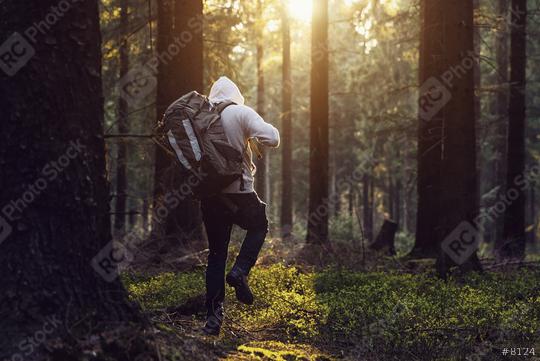 Man hiking in the woods and the sun shines through the forest  : Stock Photo or Stock Video Download rcfotostock photos, images and assets rcfotostock | RC Photo Stock.: