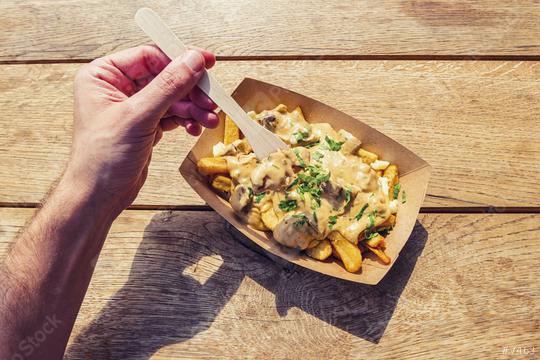 Man hold a fork to eat ench fries with mushrooms sauce on a wooden table, point of view shot.  : Stock Photo or Stock Video Download rcfotostock photos, images and assets rcfotostock | RC Photo Stock.: