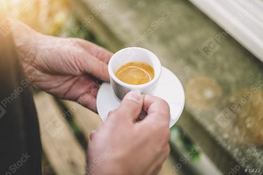 Man holding afresh tasty espresso cup of hot coffee in a cafe  : Stock Photo or Stock Video Download rcfotostock photos, images and assets rcfotostock | RC Photo Stock.: