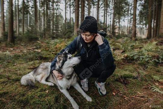 Man hugs his cute white and black husky in the forest at sunset. Friendship between dog and human, they look at each other. Autumn mood outdoors. Enjoy friendship with a pet.  : Stock Photo or Stock Video Download rcfotostock photos, images and assets rcfotostock | RC Photo Stock.: