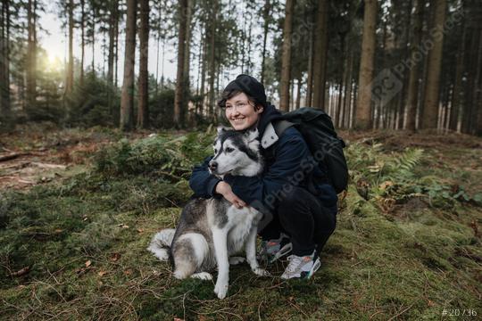 Man hugs his cute white-black husky dog friend in the forest with sunset. Outdoor autumn mood. Enjoy nature life and lovely friendship with with a pet.   : Stock Photo or Stock Video Download rcfotostock photos, images and assets rcfotostock | RC Photo Stock.:
