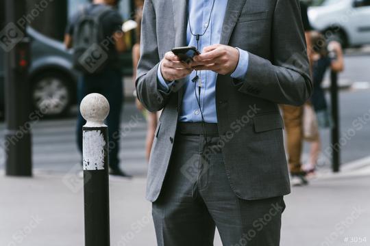 man outdoors using a smpartphone with a cable plugged into it  : Stock Photo or Stock Video Download rcfotostock photos, images and assets rcfotostock | RC-Photo-Stock.: