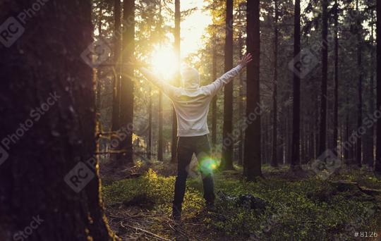 Man praying at sunset in the deep woods raised hands  : Stock Photo or Stock Video Download rcfotostock photos, images and assets rcfotostock | RC Photo Stock.:
