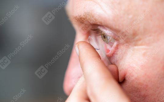 man putting contact lens in his eye on blurred background, close  : Stock Photo or Stock Video Download rcfotostock photos, images and assets rcfotostock | RC Photo Stock.: