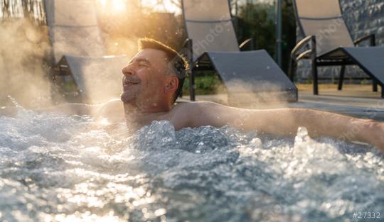 Man relaxing in a hot tub with sun rays and steam around him. Spa wellness hotel concept image.  : Stock Photo or Stock Video Download rcfotostock photos, images and assets rcfotostock | RC Photo Stock.: