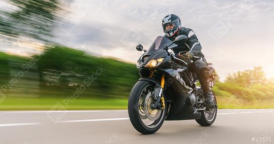 Man Riding Motorcycle On Road Against Cloudy Sky  : Stock Photo or Stock Video Download rcfotostock photos, images and assets rcfotostock | RC Photo Stock.:
