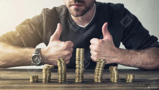 man shows thumb up with coins stack on wood table, Concept business finance or investment  : Stock Photo or Stock Video Download rcfotostock photos, images and assets rcfotostock | RC Photo Stock.: