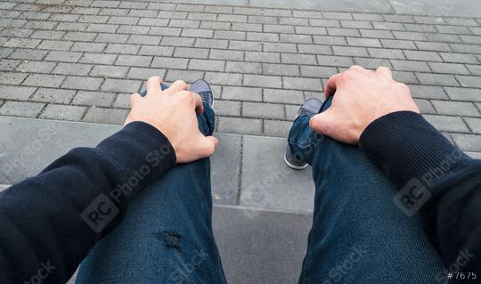 man sits on a curbstone and waits nervous for somebody, Point of view shot  : Stock Photo or Stock Video Download rcfotostock photos, images and assets rcfotostock | RC Photo Stock.: