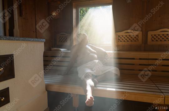 Man sitting in a sauna with light streaming through the window onto his relaxed figure.  : Stock Photo or Stock Video Download rcfotostock photos, images and assets rcfotostock | RC Photo Stock.: