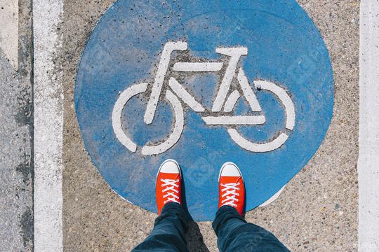 Man standing on bicycle zone sign on a asphalt city street in red sneakers, point of view perspective  : Stock Photo or Stock Video Download rcfotostock photos, images and assets rcfotostock | RC Photo Stock.: