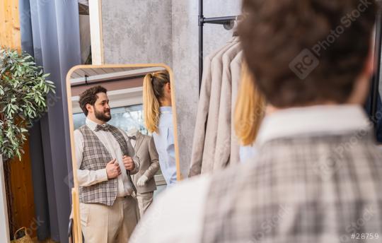 Man trying on a vest in front of a mirror in a clothing store with a tailor assisting  : Stock Photo or Stock Video Download rcfotostock photos, images and assets rcfotostock | RC Photo Stock.: