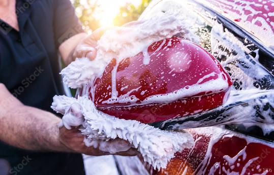 Man worker washing side mirror of a red car with sponge on a car wash.  : Stock Photo or Stock Video Download rcfotostock photos, images and assets rcfotostock | RC Photo Stock.: