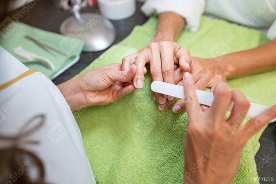 Manicurist buffing nails during a manicure session in a beauty salon. body care spa treatment concept image  : Stock Photo or Stock Video Download rcfotostock photos, images and assets rcfotostock | RC Photo Stock.: