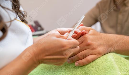 Manicurist filing nails for a male client in a beauty salon. body care spa treatment concept image  : Stock Photo or Stock Video Download rcfotostock photos, images and assets rcfotostock | RC Photo Stock.: