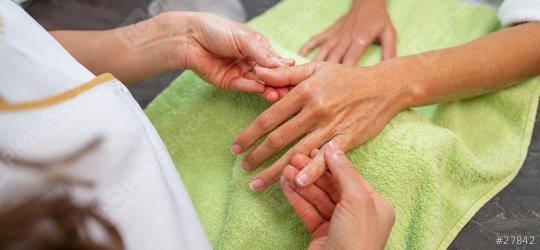 Manicurist massaging female client hand during a manicure session in a beauty salon  : Stock Photo or Stock Video Download rcfotostock photos, images and assets rcfotostock | RC Photo Stock.: