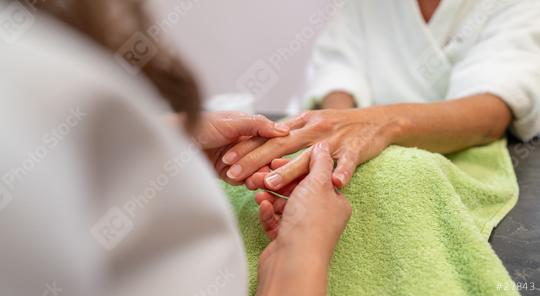 Manicurist massaging womans hand during a manicure session in a beauty salon. body care spa treatment concept image  : Stock Photo or Stock Video Download rcfotostock photos, images and assets rcfotostock | RC Photo Stock.: