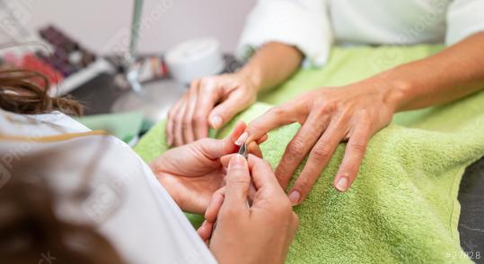 Manicurist trimming cuticles of a client at a salon with tools on table  in a beauty salon. body care spa treatment concept image  : Stock Photo or Stock Video Download rcfotostock photos, images and assets rcfotostock | RC Photo Stock.: