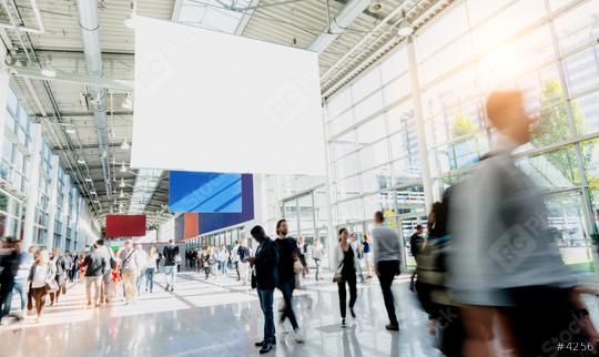 Many trade fair visitors walk under a blank billboard through a hall  : Stock Photo or Stock Video Download rcfotostock photos, images and assets rcfotostock | RC Photo Stock.: