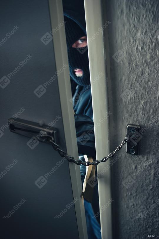 masked burglar use crowbar to breaking into a home door with chain  : Stock Photo or Stock Video Download rcfotostock photos, images and assets rcfotostock | RC Photo Stock.: