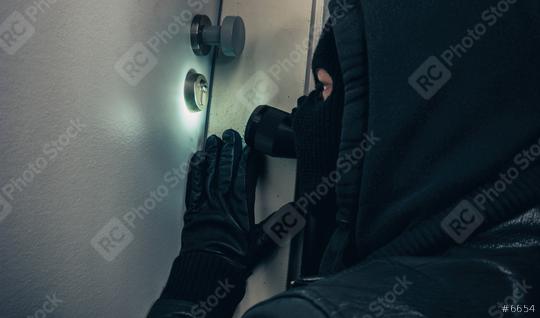 Masked burglar with flashlight breaking into a house door at night  : Stock Photo or Stock Video Download rcfotostock photos, images and assets rcfotostock | RC Photo Stock.: