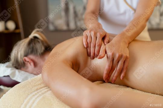 Massage therapist working on woman