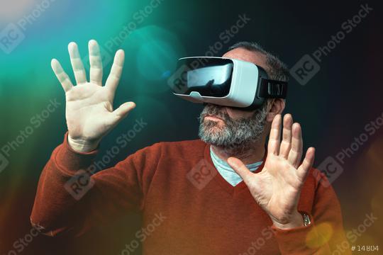 Mature business man wearing virtual reality googles / VR Glasses to work with in modern office  : Stock Photo or Stock Video Download rcfotostock photos, images and assets rcfotostock | RC Photo Stock.: