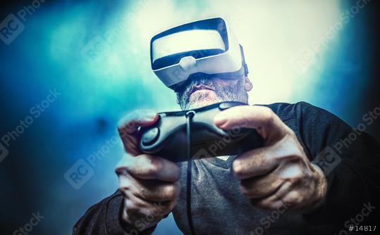 Mature man wearing virtual reality goggles / VR Glasses to play video games  : Stock Photo or Stock Video Download rcfotostock photos, images and assets rcfotostock | RC Photo Stock.: