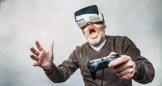 Mature man wearing virtual reality goggles / VR Glasses to play video games  : Stock Photo or Stock Video Download rcfotostock photos, images and assets rcfotostock | RC Photo Stock.: