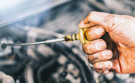 Mechanic repairing car with open hood,Side view of mechanic checking level motor oil in a car with open hood  : Stock Photo or Stock Video Download rcfotostock photos, images and assets rcfotostock | RC Photo Stock.: