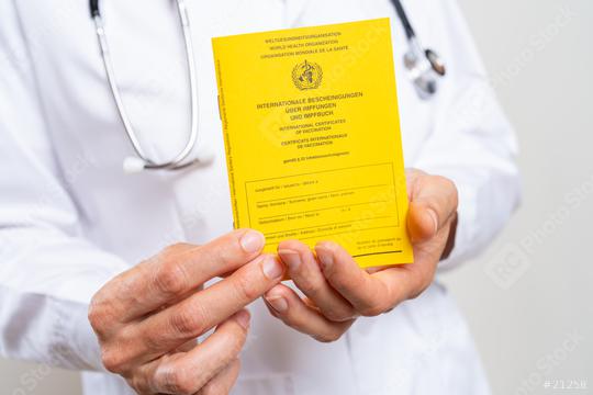 Medical Doctor showing an international certificate of the vaccination for coronavirus, covid-19 or flu, measles vaccine  : Stock Photo or Stock Video Download rcfotostock photos, images and assets rcfotostock | RC Photo Stock.: