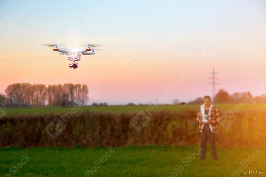 Modern RC UAV Drone / Quadcopter with camera flying on a clear sunny sky   : Stock Photo or Stock Video Download rcfotostock photos, images and assets rcfotostock | RC Photo Stock.: