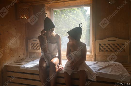 Mother and daughter in a sauna, both wearing felt hats, enjoying a conversation in a spa hotel  : Stock Photo or Stock Video Download rcfotostock photos, images and assets rcfotostock | RC Photo Stock.: