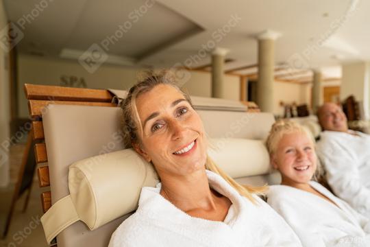 mother and her daughter smiling at the camera, with the father in the background, all relaxing in a spa lounge  : Stock Photo or Stock Video Download rcfotostock photos, images and assets rcfotostock | RC Photo Stock.: