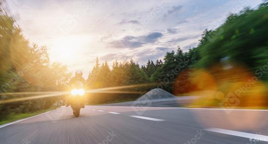 motorbike on the forest road riding with motion speed. driving on the empty road on a motorcycle tour at sunset. copyspace for your individual text.  : Stock Photo or Stock Video Download rcfotostock photos, images and assets rcfotostock | RC Photo Stock.: