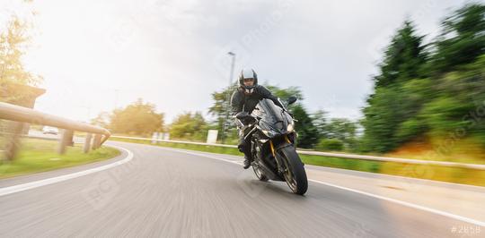 motorbike on the road riding in a curve with motion speed on a motorcycle tour. copyspace for your individual text.  : Stock Photo or Stock Video Download rcfotostock photos, images and assets rcfotostock | RC Photo Stock.: