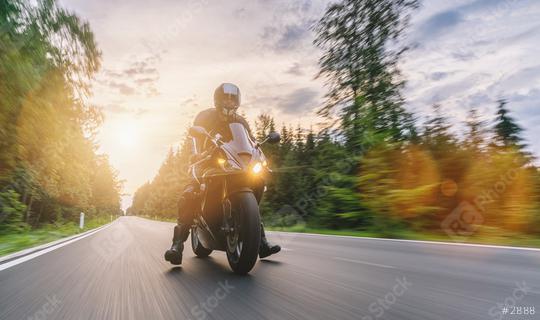 motorbike on the road riding with motion speed. driving on the empty road on a motorcycle tour at sunset. copyspace for your individual text.  : Stock Photo or Stock Video Download rcfotostock photos, images and assets rcfotostock | RC Photo Stock.: