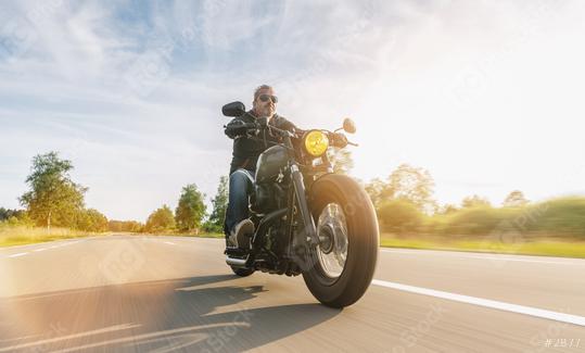 Motorcycle driver riding cruiser on the highway, central Europe.  : Stock Photo or Stock Video Download rcfotostock photos, images and assets rcfotostock | RC Photo Stock.:
