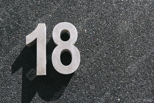 number 18 hanging of a black concrete wall  : Stock Photo or Stock Video Download rcfotostock photos, images and assets rcfotostock | RC Photo Stock.: