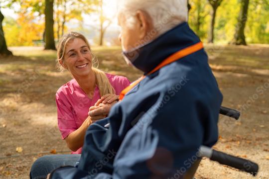 Nurse smiling and holding hands with elderly man in wheelchair, autumn leaves and sunlight in background  : Stock Photo or Stock Video Download rcfotostock photos, images and assets rcfotostock | RC Photo Stock.: