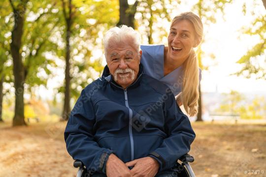 nurse visiting her elderly patient in nursing home having a walk in the park with him in a wheelchair, both smiling brightly  : Stock Photo or Stock Video Download rcfotostock photos, images and assets rcfotostock | RC Photo Stock.: