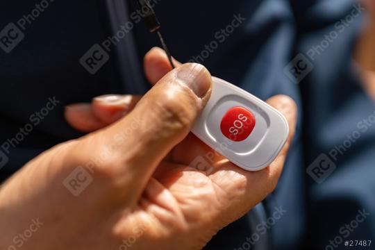 old hand holding an SOS button, highlighting its use for emergencies with focus on the red button  : Stock Photo or Stock Video Download rcfotostock photos, images and assets rcfotostock | RC Photo Stock.: