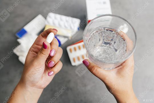 one round white pill in young female hand and Glass of Water for medication. Health care and medical concept.  : Stock Photo or Stock Video Download rcfotostock photos, images and assets rcfotostock | RC Photo Stock.: